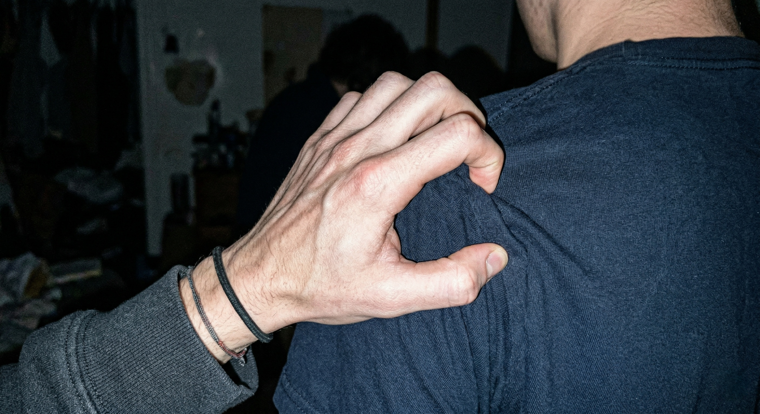 raw-iphone-flash-photo-of-hand-gripping-shoulder-texture